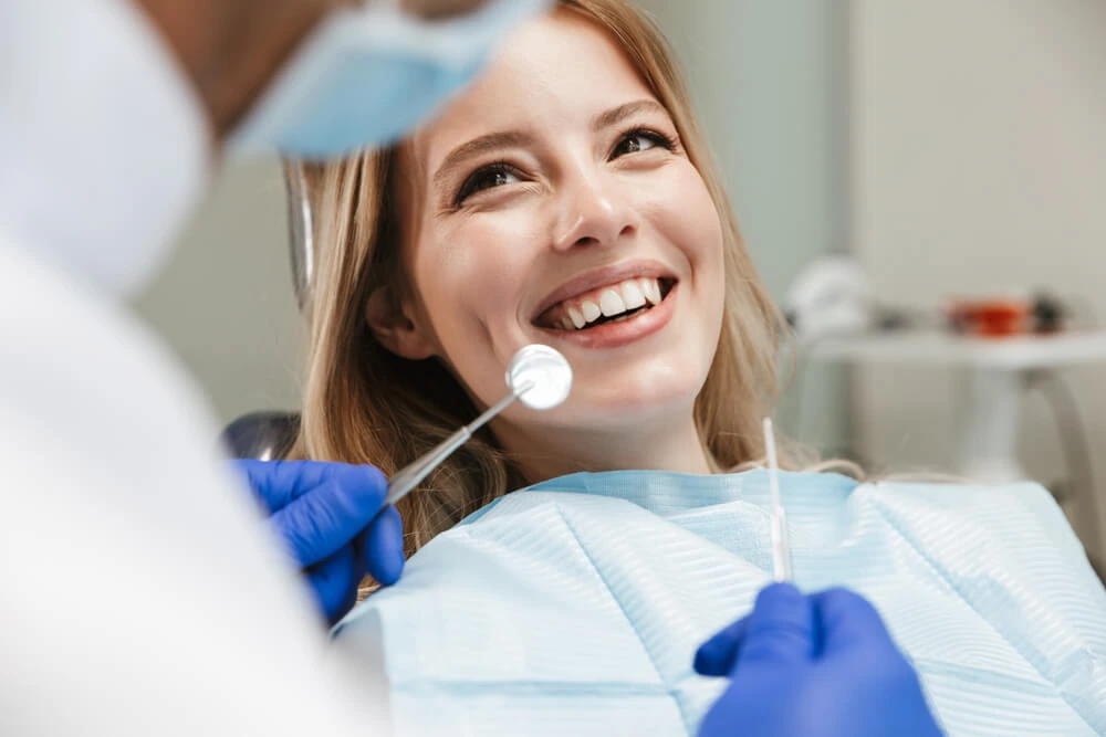 Young woman smiling during a dental checkup.