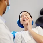 Patient holding cheek during dental checkup