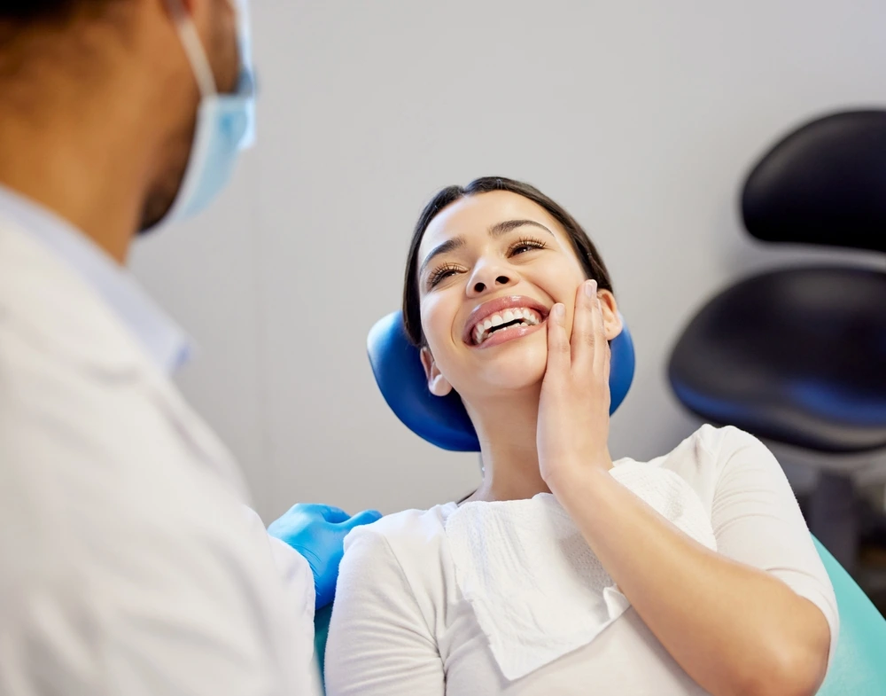 Patient holding cheek during dental checkup